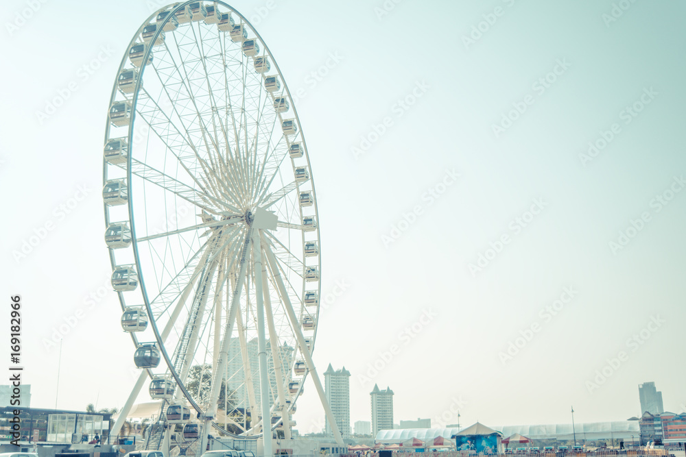 The large Ferris wheel is a player with a high angle view with pastel coloring