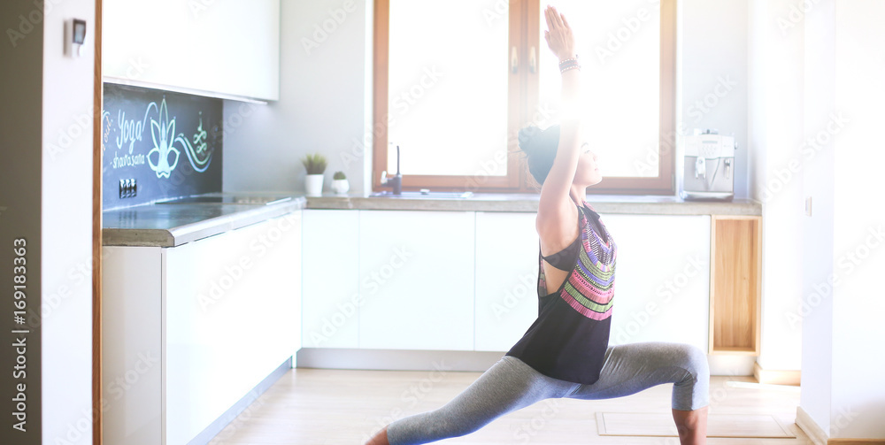 Asian woman are yoga exercises at home
