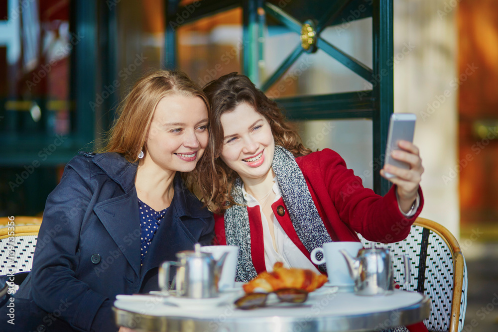 Two young girls in Parisian outdoor cafe