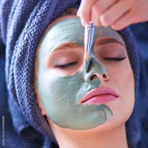 Beautiful woman having mask , lying on spa photo