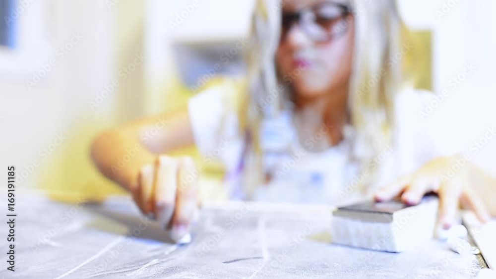 Little girl writing to the copy blackboard Little girl writing to the copy blackboard