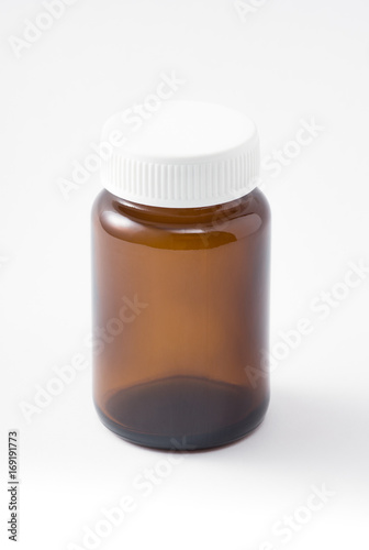 empty light brown medical bottle with white plastic lid have some scratch on white background