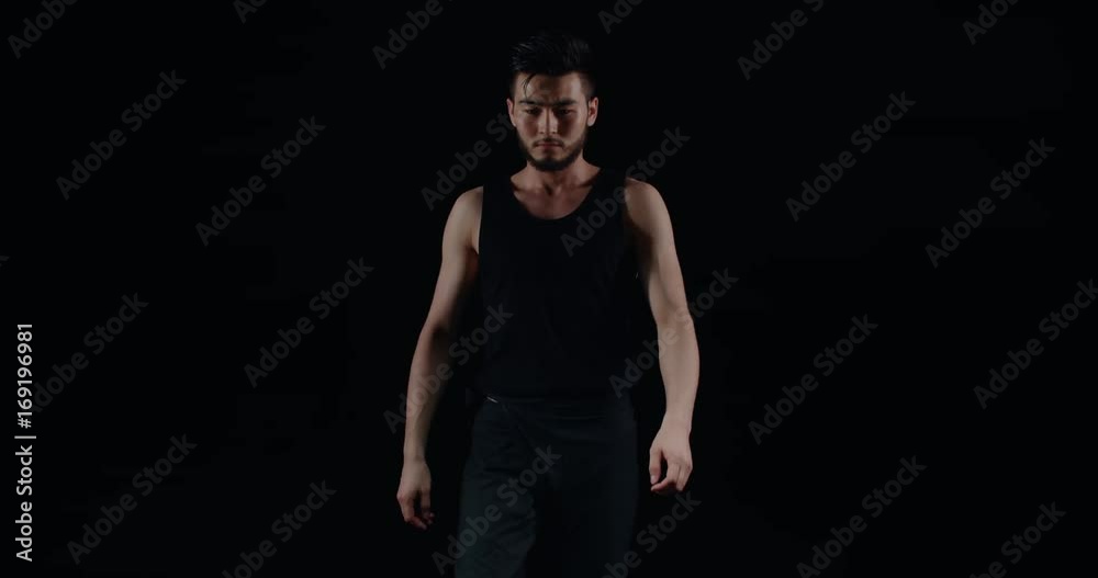 the beginning of a performance of Taiko , Asian male drummer in black clothes suitable to the drums and starts to beat the rhythm the beginning of a performance of Taiko , Asian male drummer in black clothes suitable to the drums and starts to beat the rhythm