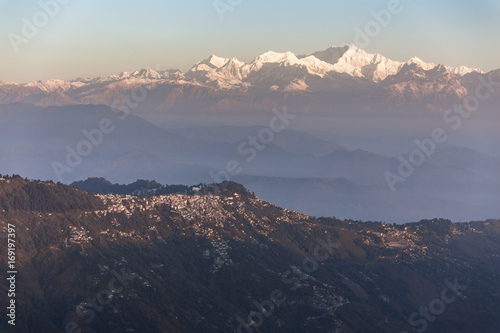 Kangchenjunga mountain in the morning with blue and orange sky and mountain villages that view from The Tiger Hill in winter at Tiger Hill, Darjeeling. India. photo