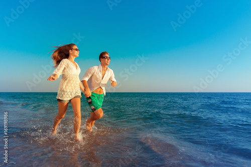 Happy young couple enjoying the sea