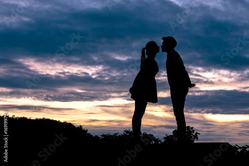 Silhouette couple in love Men ask for married and kissing on beautiful sunset background , valentine concept