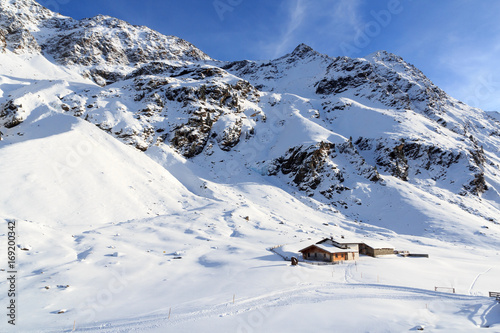 Alpine chalet house and mountain panorama with snow in winter in Stubai Alps, Austria © johannes86