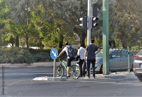 man are waiting on the triffic light