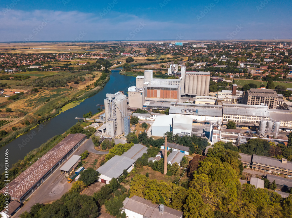 Drone pov, aerial view of industrial cityscape with factory buildings