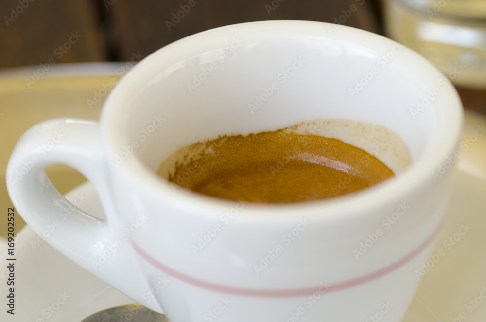 Closeup photo of a cup of espresso coffee standing on a table Closeup photo of a cup of espresso coffee standing on a table