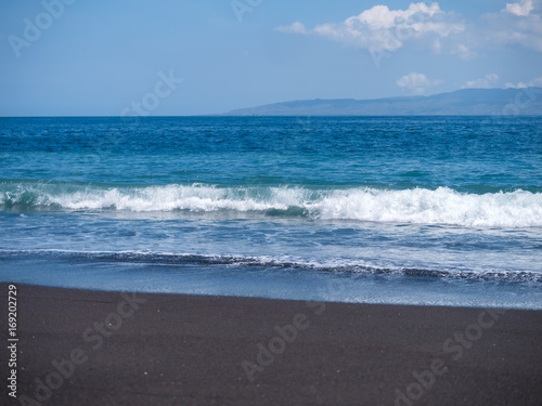 Black volcanic beach in eastern Bali Indonesia