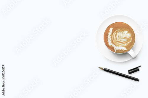 White office desk table with cup of latte coffee and pen. Top view with copy space, flat lay.