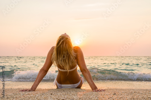 Woman in white bikini on the beach