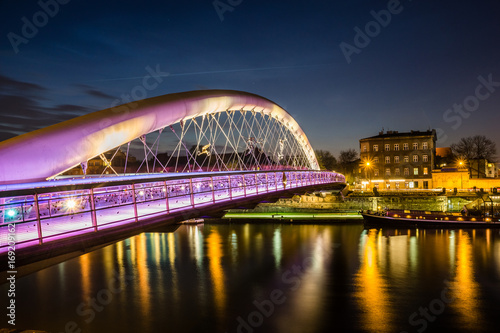 Bernatka footbridge over Vistula river at night in Cracow, Poland