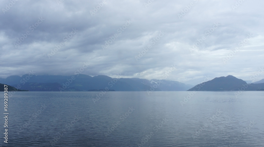 Silhouette of hills, view from the ferry, cloudy weather, Norway, Scandinavian landscape