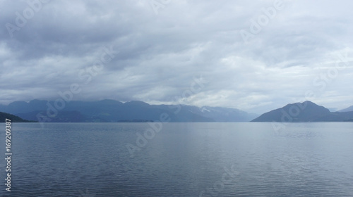 Silhouette of hills, view from the ferry, cloudy weather, Norway, Scandinavian landscape © Lunnaya