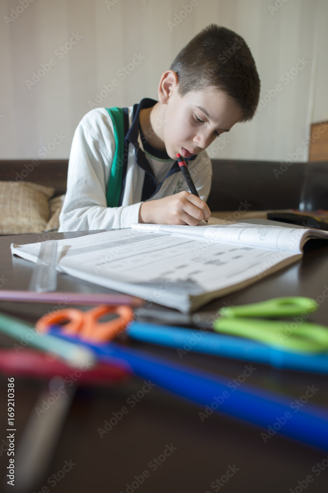 Child do his homework. Hand hold pen. Boy learning Child do his homework. Hand hold pen. Boy learning