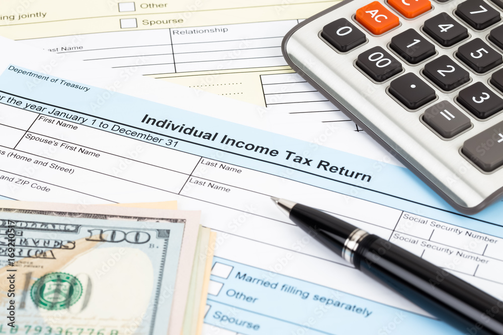 Tax form with calculator, pen, and dollar banknote; document are mock-up Tax form with calculator, pen, and dollar banknote; document are mock-up