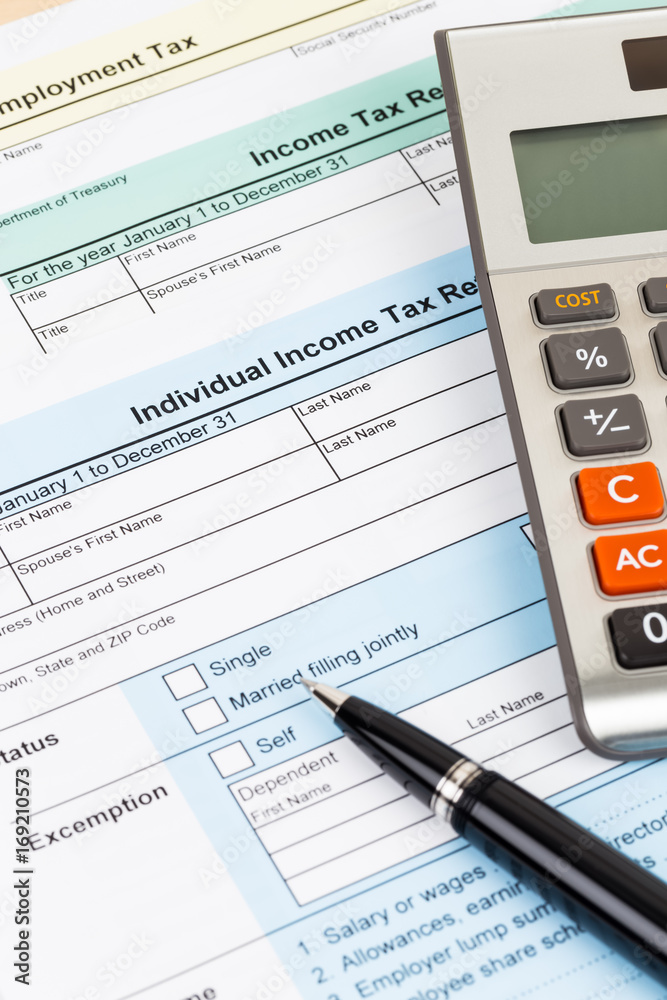 Tax form with pen and calculator; document are mock-up Tax form with pen and calculator; document are mock-up