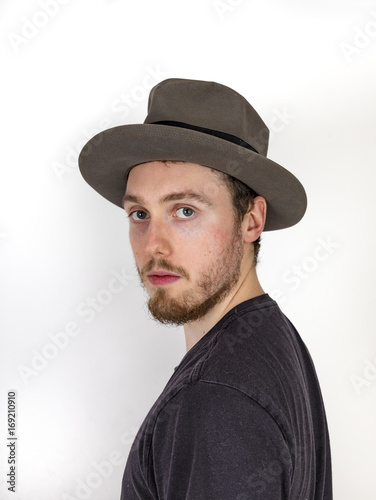 portrait of cool looking young man looking mature man with hat
