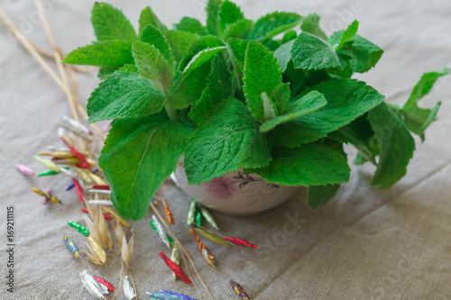 Twigs of fresh mint, cooked for tea, together with a dacor made of butterflies. photo