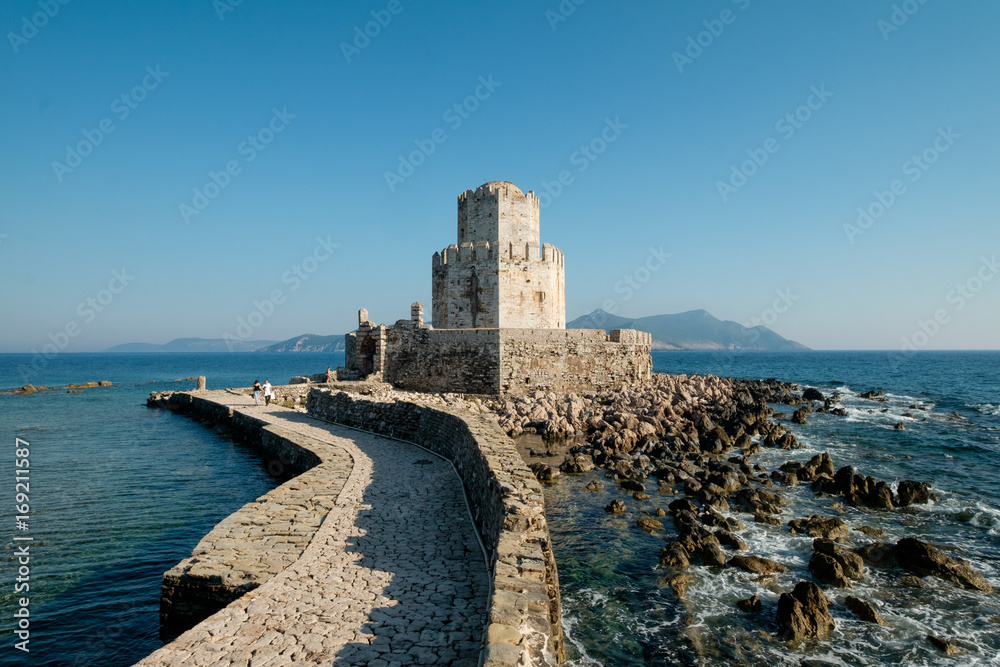Big ancient fortress castle building on shore island in Greece