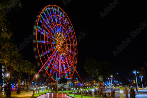 The bright ferris wheel is one of the most popular attractions in city