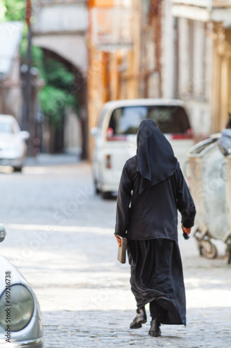 Christian nuns walking down the street © Andrey Cherkasov