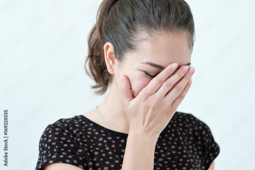 Playful shy woman hiding face with her hands Playful shy woman hiding face with her hands