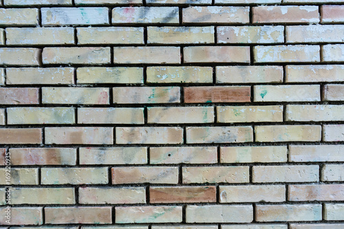brick wall with single orange bricks close up structure