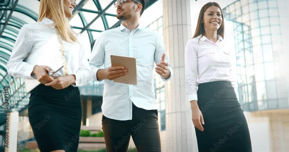 Picture of young attractive business partners standing Picture of young attractive business partners standing