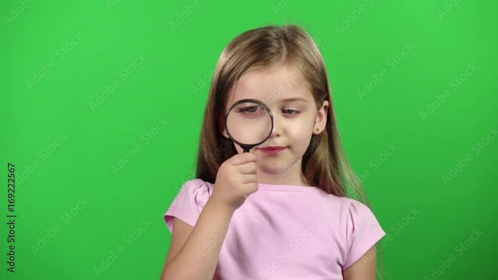 Child is holding a magnifying glass. Green screen. Slow motion Child is holding a magnifying glass. Green screen. Slow motion