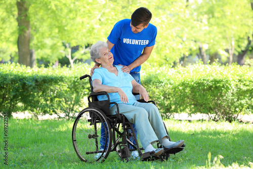 Happy senior woman on wheel...