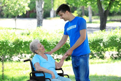 Happy senior woman on wheel...