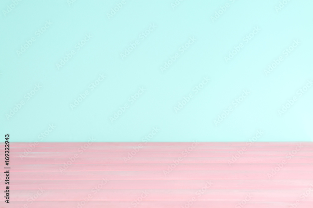 Wooden table against mint color background Wooden table against mint color background
