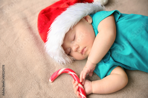 Cute little baby in Santa h...
