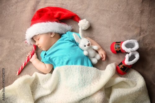 Cute little baby in Santa h...