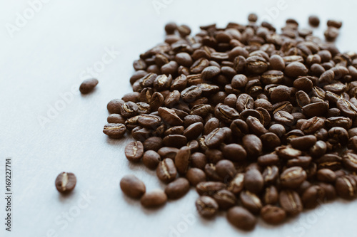 Dark brown natural coffee beans laying on a table. Ingredients for espresso  cappuccino or latte.