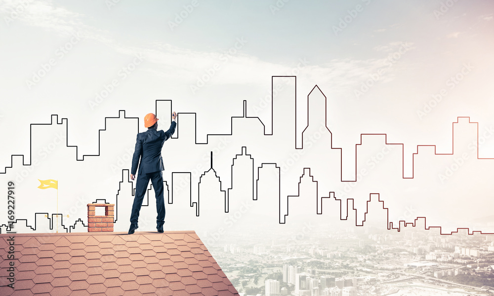 Man architect draw silhouette of modern city on blue sky. Mixed Man architect draw silhouette of modern city on blue sky. Mixed