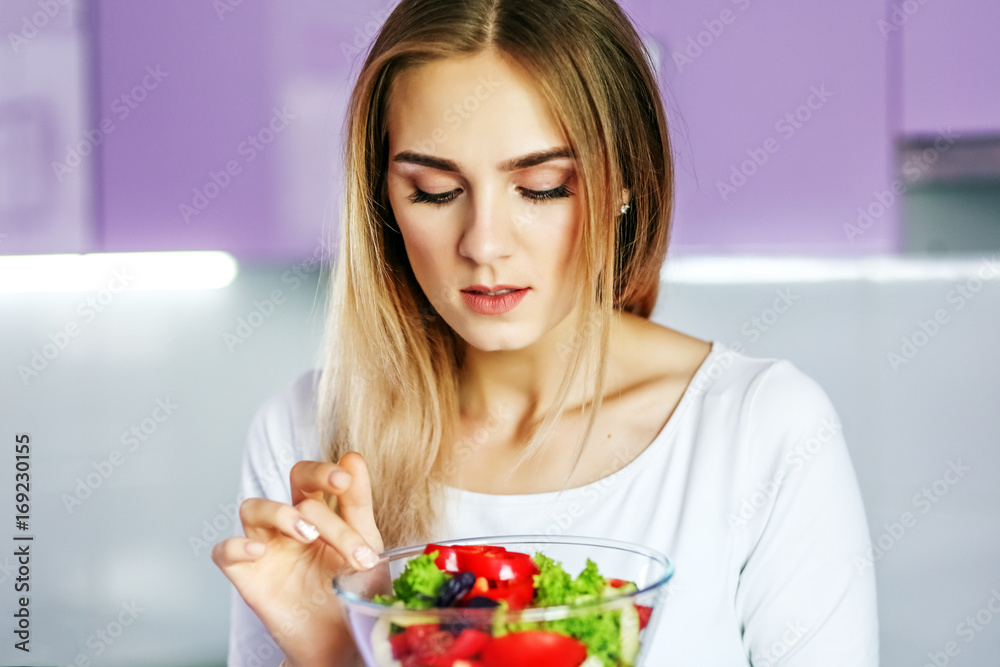 Young girl eats vegetable salad. The concept is healthy food, diet, vegetarianism, weight loss. Young girl eats vegetable salad. The concept is healthy food, diet, vegetarianism, weight loss.