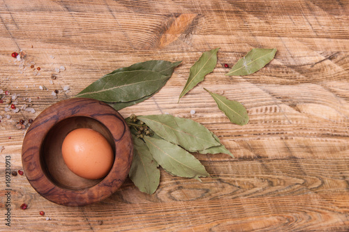 Raw egg on wooden background, top view.