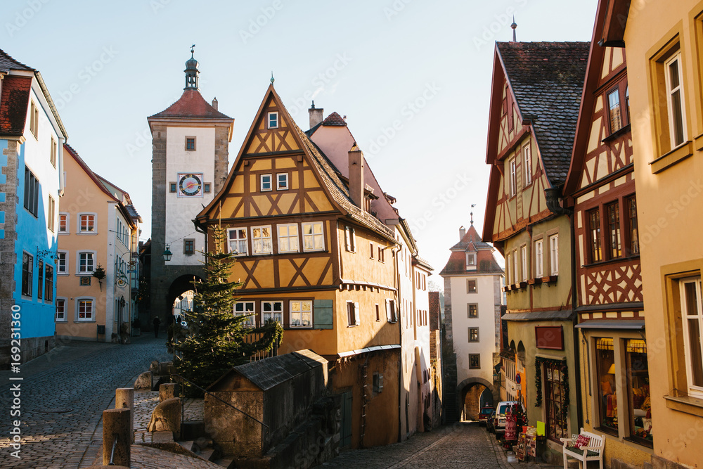 A beautiful street in Rothenburg ob der Tauber with beautiful houses in German style during the Christmas holidays. Christmas Germany without snow. Celebrating Christmas in Europe.