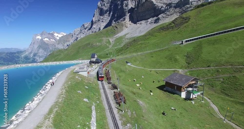 AERIAL VIDEO TOP OF ATTRACTION SWITZERLAND. JUNGFRAU MOUNTAIN LANDSCAPE WIT FAMOUS RED TRAIN