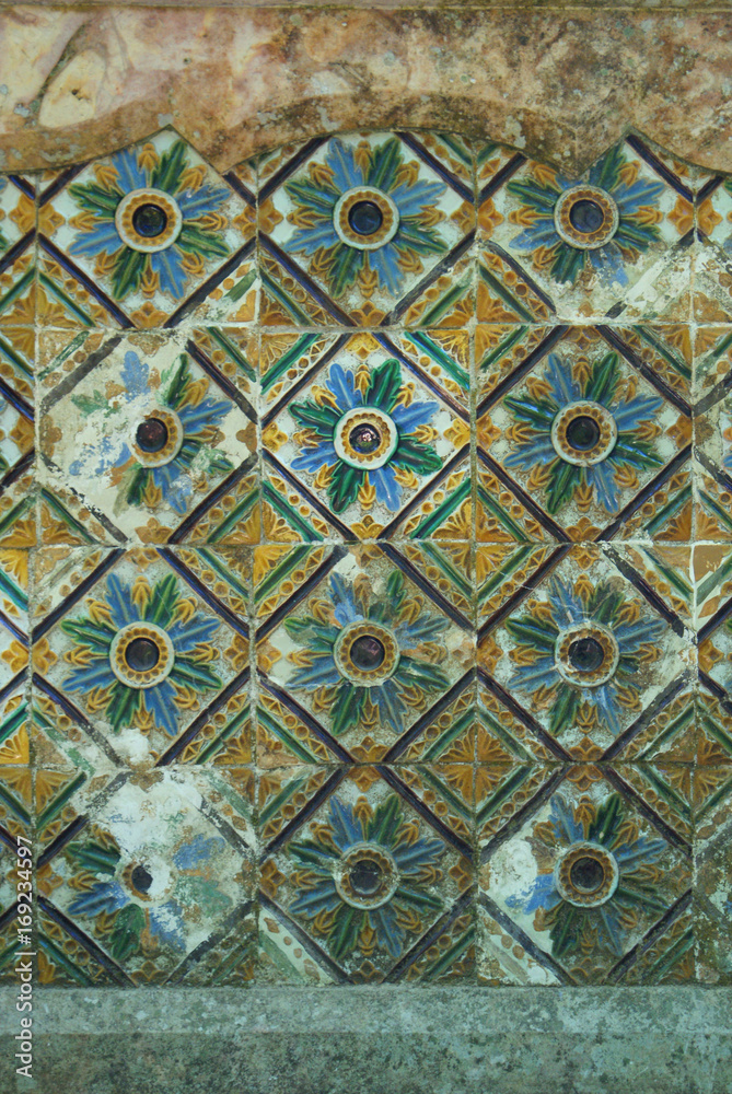 Distressed old floral tiles on a building in Lisbon