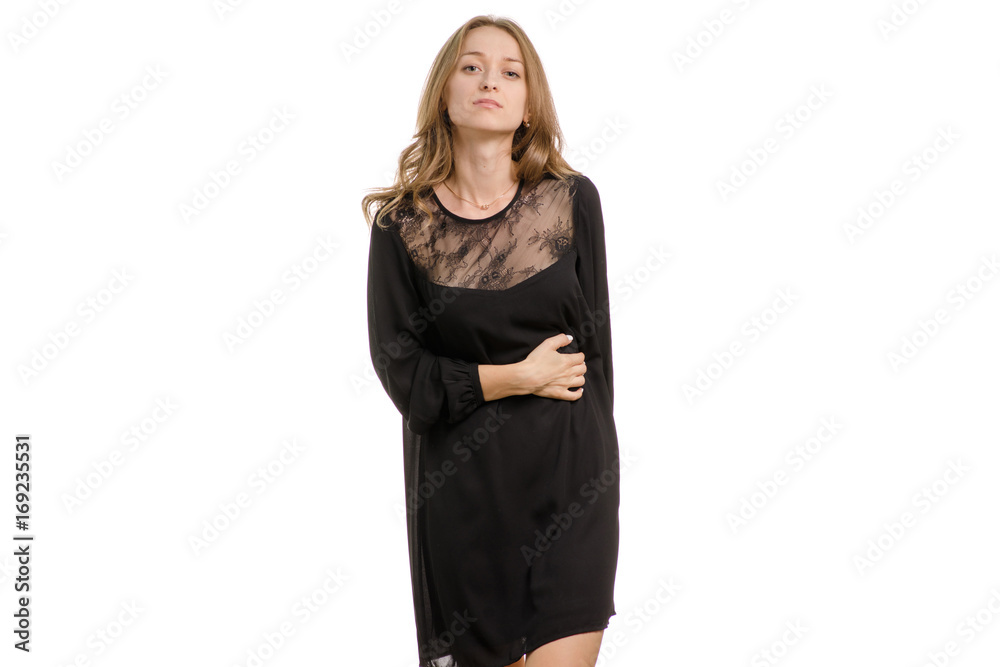 A girl in a black dress is holding a hi-tech pain in the abdomen