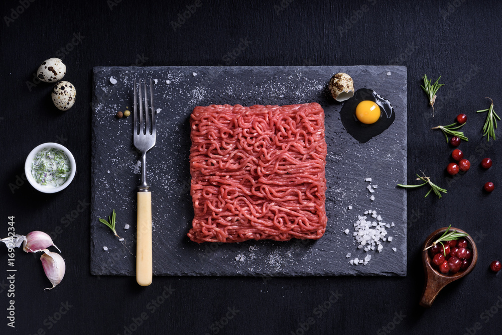 Fresh butcher cut meat minced, garnished, served with cooking ingredients. Fresh butcher cut meat minced, garnished, served with cooking ingredients.