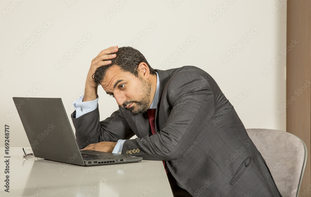 arab man woking in his laptop in the kitchen arab man woking in his laptop in the kitchen