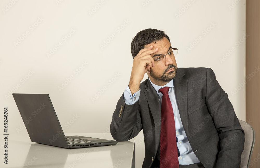 arab man woking in his laptop in the kitchen arab man woking in his laptop in the kitchen