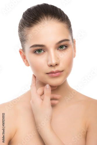 Portrait of beautiful young brunette woman with clean face. Beauty spa model girl with perfect fresh clean skin. Looking at camera and smiling. Youth and skin care concept. Isolated on a white