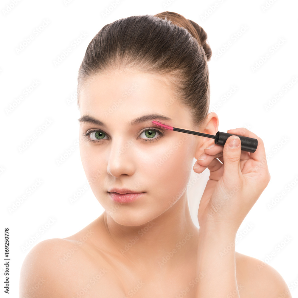 Eye make up apply. Mascara applying closeup, long lashes. Mascara brush. Portrait of beautiful young brunette woman with perfect fresh clean face skin. Eyelashes extensions. Make-up for green eyes Eye make up apply. Mascara applying closeup, long lashes. Mascara brush. Portrait of beautiful young brunette woman with perfect fresh clean face skin. Eyelashes extensions. Make-up for green eyes